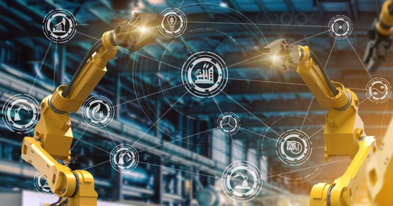 Yellow production facilities in front of connected icons representing the digitalisation of the industry.